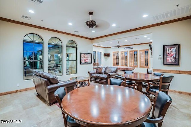 dining space featuring ceiling fan and crown molding