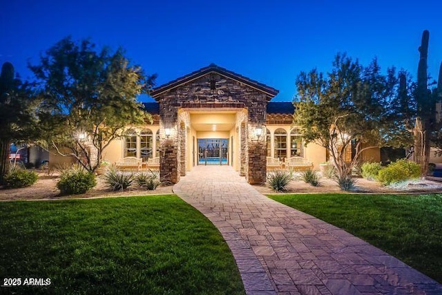 mediterranean / spanish-style home featuring a front lawn