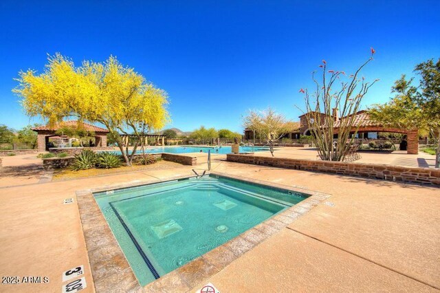 view of swimming pool with a gazebo and a community hot tub