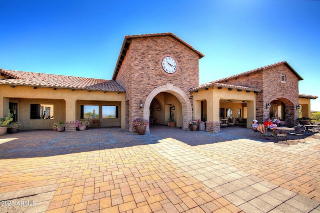 rear view of house with outdoor lounge area and a patio