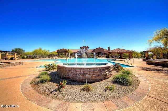 view of swimming pool featuring a gazebo and pool water feature