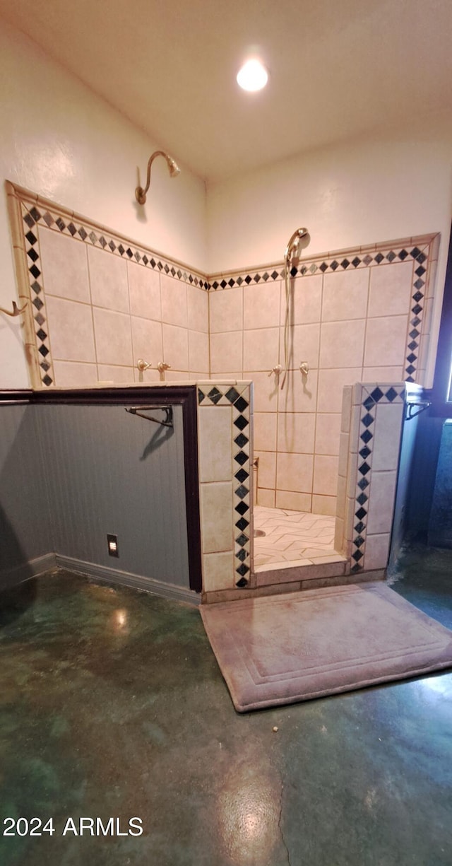 bathroom featuring concrete flooring and tiled shower