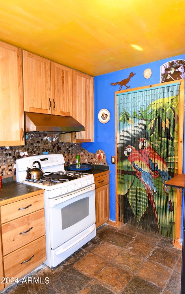 kitchen with backsplash and white gas range oven