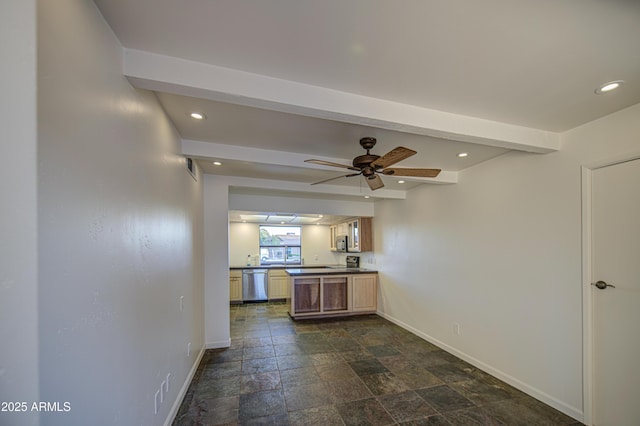 kitchen with baseboards, stainless steel appliances, dark countertops, and stone tile flooring