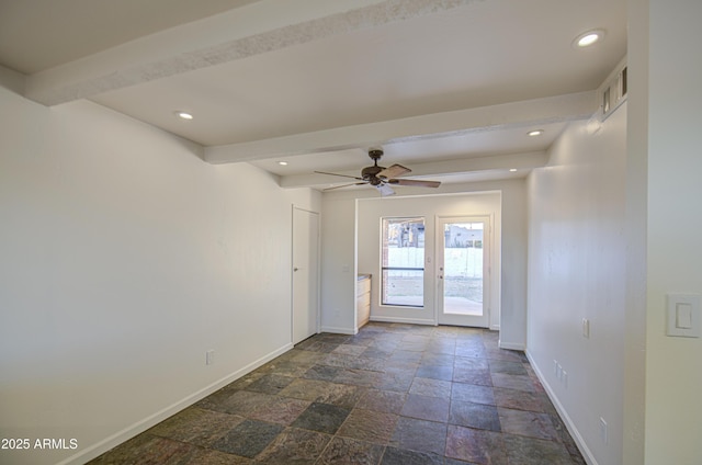 unfurnished room with beamed ceiling, stone tile floors, ceiling fan, and baseboards