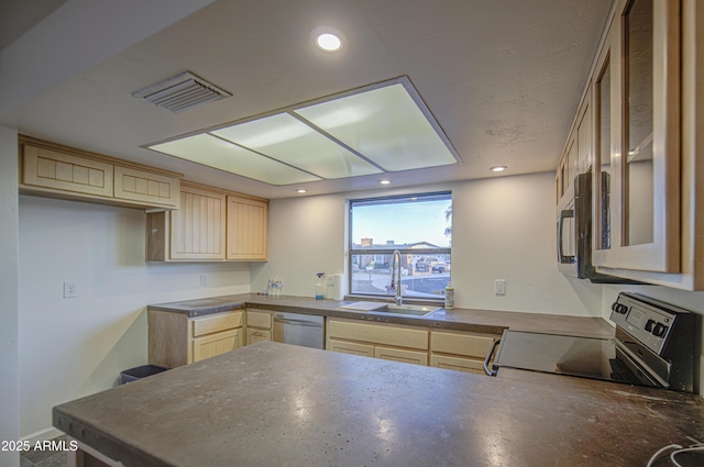 kitchen featuring light brown cabinets, stainless steel appliances, a peninsula, and a sink