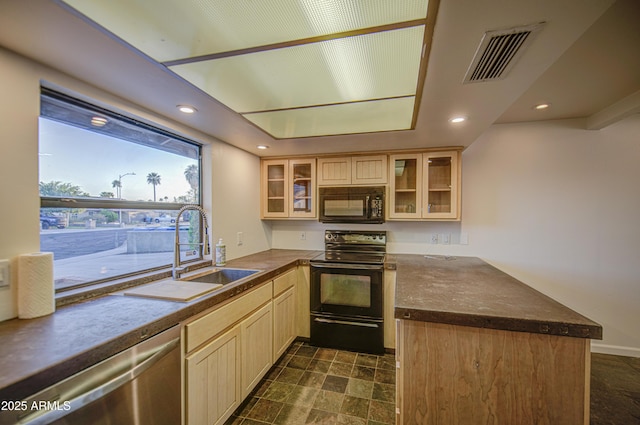 kitchen with a sink, glass insert cabinets, black appliances, visible vents, and a peninsula