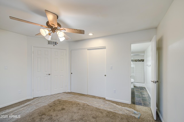 unfurnished bedroom featuring carpet, visible vents, a ceiling fan, and baseboards