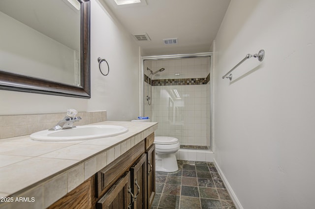 full bath with toilet, visible vents, a shower stall, and vanity