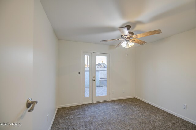 spare room featuring a ceiling fan, carpet floors, and baseboards