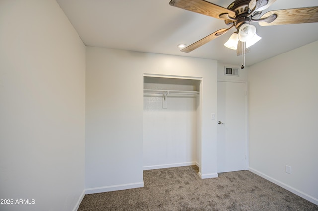 unfurnished bedroom featuring visible vents, a closet, baseboards, carpet floors, and a ceiling fan