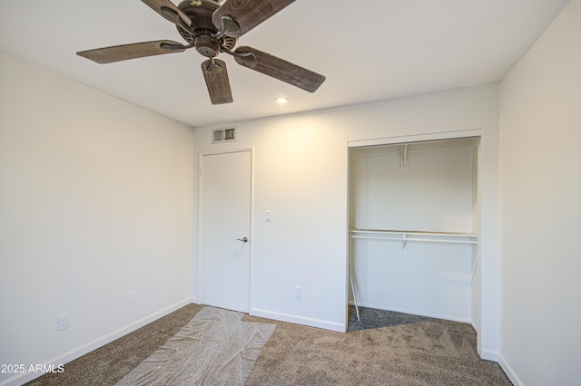 unfurnished bedroom featuring a closet, visible vents, carpet, and baseboards