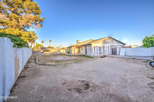 rear view of property with fence