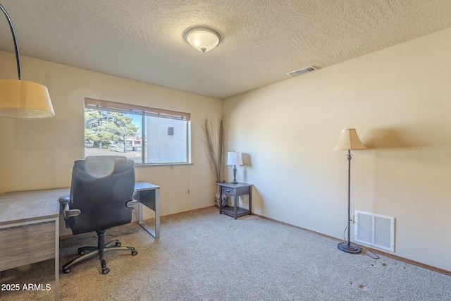 office with a textured ceiling and carpet