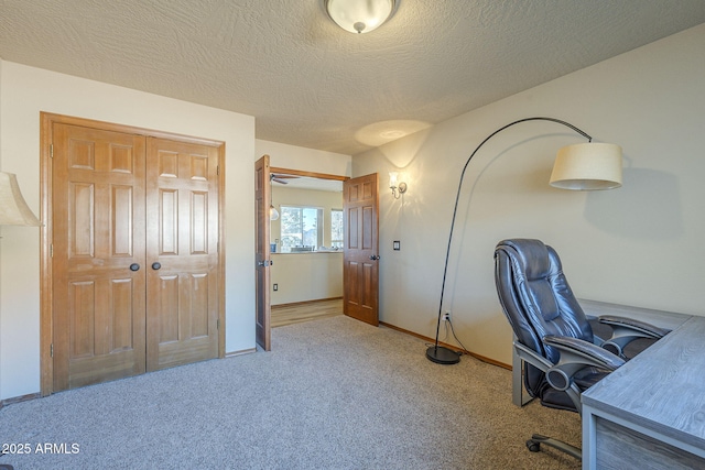 office with a textured ceiling and carpet