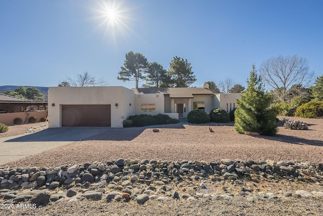 pueblo-style home with a garage