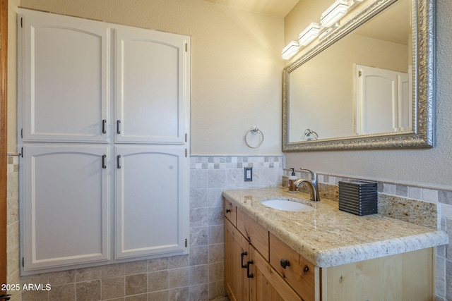 bathroom featuring tile walls and vanity