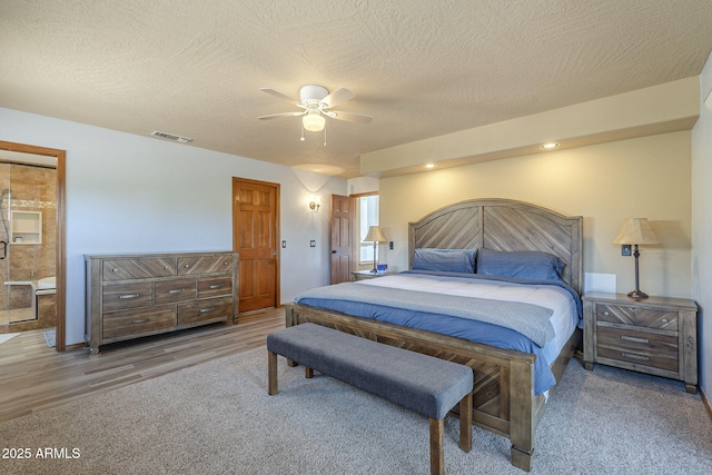 bedroom featuring ceiling fan, a textured ceiling, and hardwood / wood-style flooring