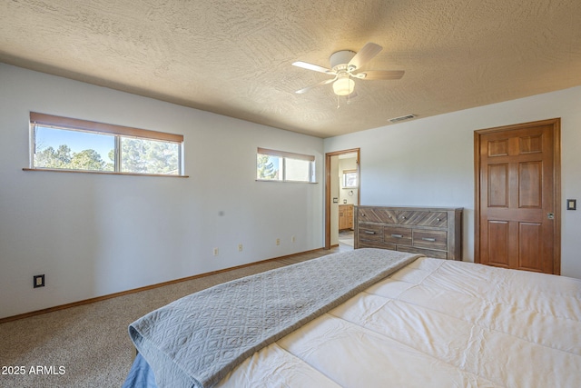 carpeted bedroom with a textured ceiling and ceiling fan