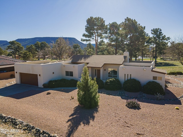 view of front of home featuring a garage and a mountain view