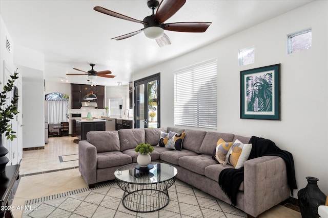 living room with light tile patterned floors and a ceiling fan