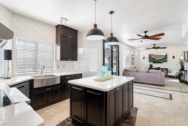 kitchen featuring a center island, light countertops, and a sink