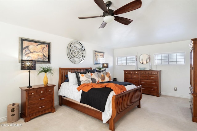 bedroom featuring light carpet, ceiling fan, and baseboards