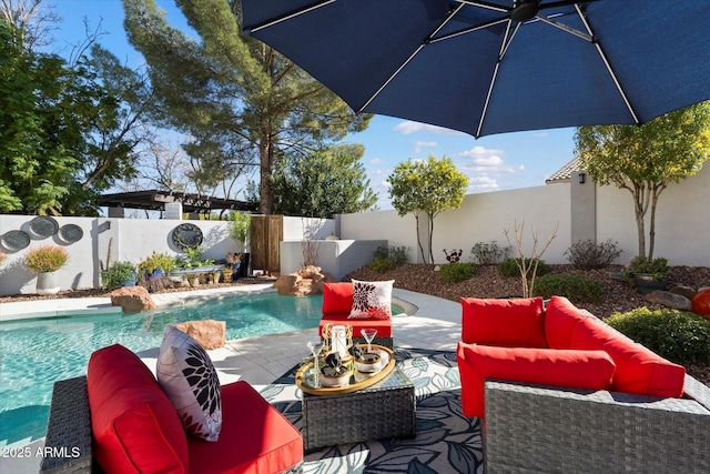 view of swimming pool featuring a patio, outdoor lounge area, a fenced backyard, and a fenced in pool