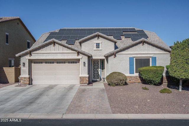 view of front facade featuring a garage and solar panels