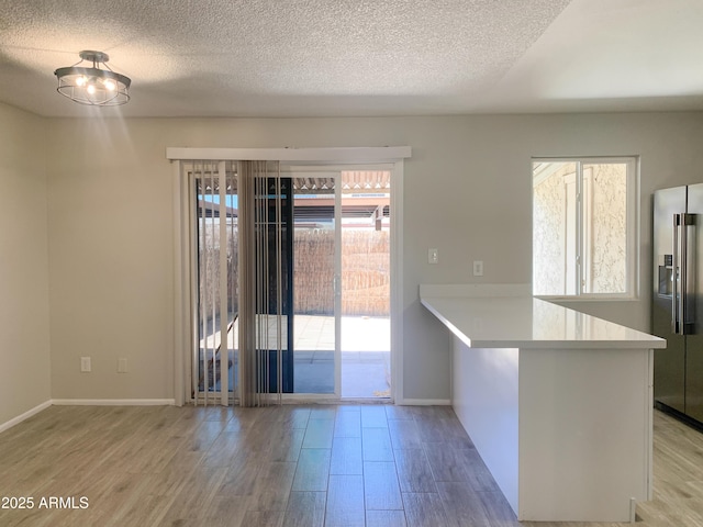 2155 W Farmdale Ave Unit 8, Mesa, AZ 85202 - unfurnished dining area with wood finished floors, a textured ceiling, and baseboards