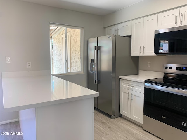 2155 W Farmdale Ave Unit 8, Mesa, AZ 85202 - kitchen with stainless steel appliances, a peninsula, light countertops, and white cabinets