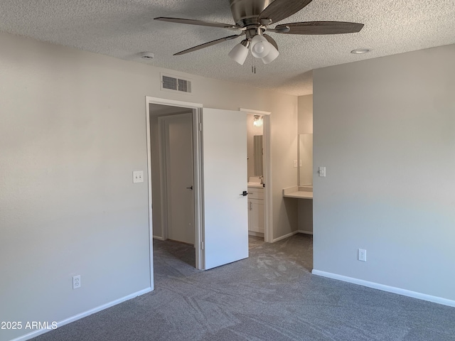 2155 W Farmdale Ave Unit 8, Mesa, AZ 85202 - unfurnished bedroom featuring a textured ceiling, carpet floors, baseboards, connected bathroom, and a ceiling fan