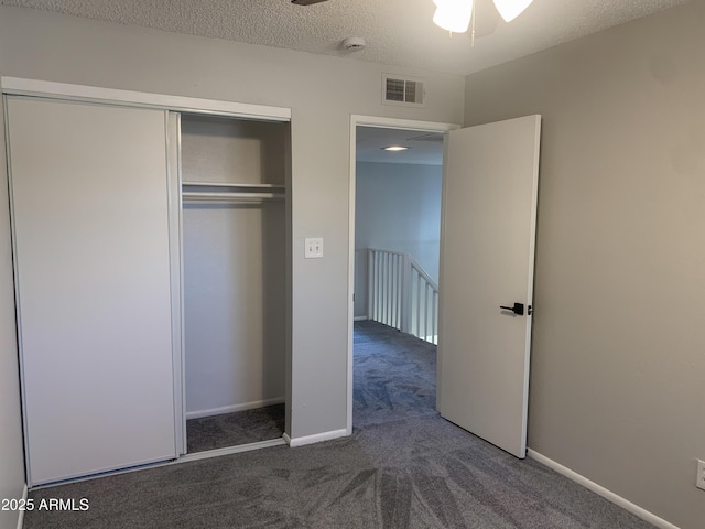 2155 W Farmdale Ave Unit 8, Mesa, AZ 85202 - unfurnished bedroom featuring carpet flooring, a closet, a textured ceiling, and baseboards