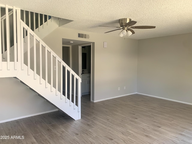 2155 W Farmdale Ave Unit 8, Mesa, AZ 85202 - unfurnished living room with ceiling fan, wood finished floors, stairs, a textured ceiling, and baseboards