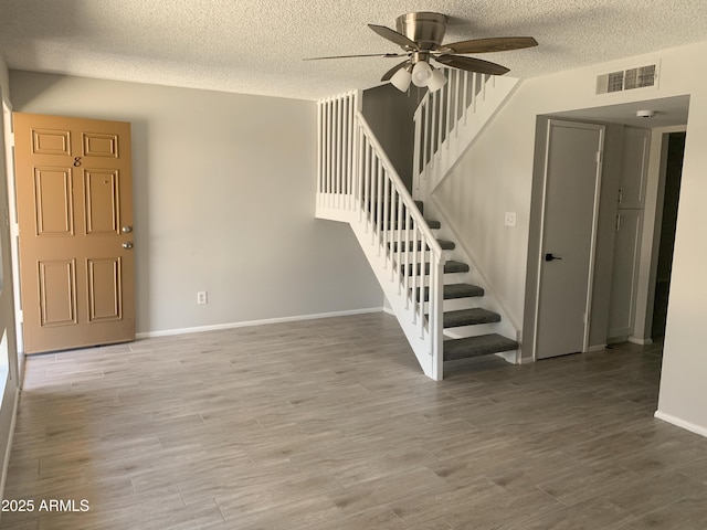 2155 W Farmdale Ave Unit 8, Mesa, AZ 85202 - entryway with a textured ceiling, ceiling fan, stairway, wood finished floors, and baseboards