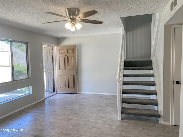 2155 W Farmdale Ave Unit 8, Mesa, AZ 85202 - foyer entrance featuring healthy amount of natural light, a textured ceiling, ceiling fan, baseboards, and stairway