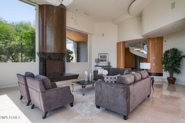 living room featuring a high ceiling and a premium fireplace