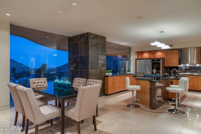 dining room featuring recessed lighting and tile walls