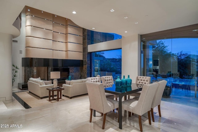 dining room with recessed lighting, visible vents, and a towering ceiling