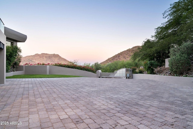 view of patio with fence and a mountain view