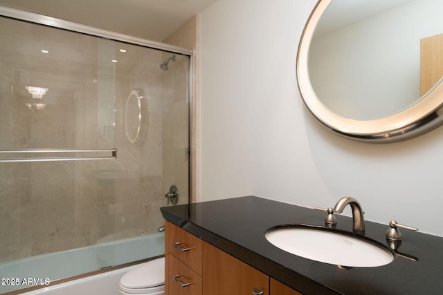 bathroom featuring shower / bath combination with glass door, vanity, and toilet