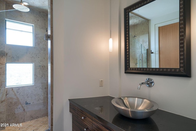 bathroom featuring a shower stall and vanity