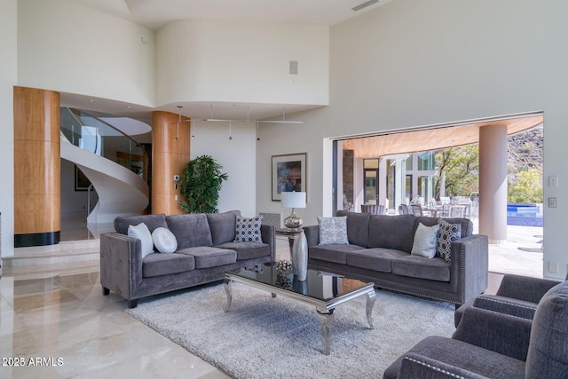 living room featuring marble finish floor and a high ceiling