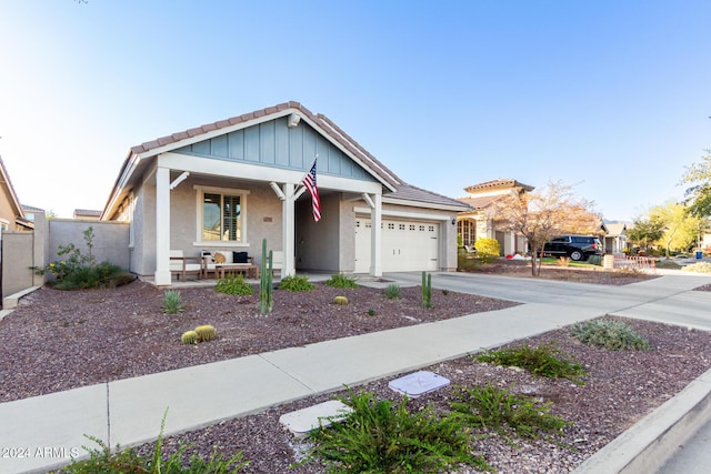 view of front of property with a porch and a garage