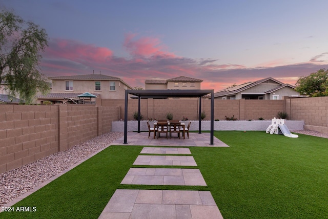 yard at dusk featuring a gazebo and a patio