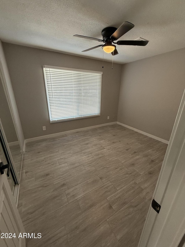 2429 E Alameda Dr, Tempe, AZ 85282 - spare room with a textured ceiling, baseboards, and ceiling fan