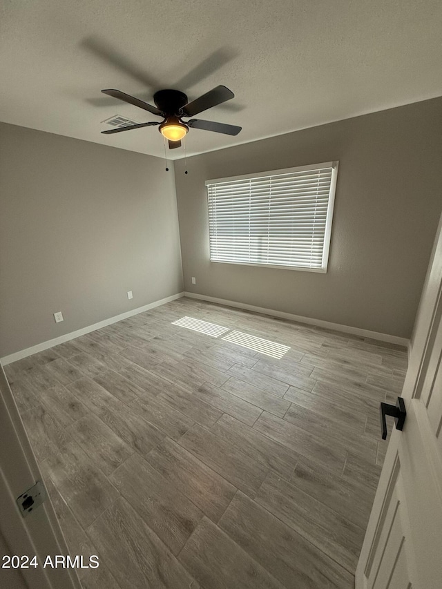 2429 E Alameda Dr, Tempe, AZ 85282 - unfurnished room with wood finished floors, baseboards, and ceiling fan