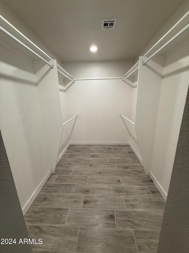 2429 E Alameda Dr, Tempe, AZ 85282 - walk in closet featuring wood finished floors and visible vents