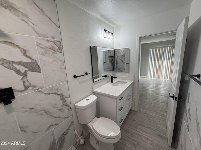 2429 E Alameda Dr, Tempe, AZ 85282 - bathroom featuring wood finished floors, vanity, a textured ceiling, and toilet
