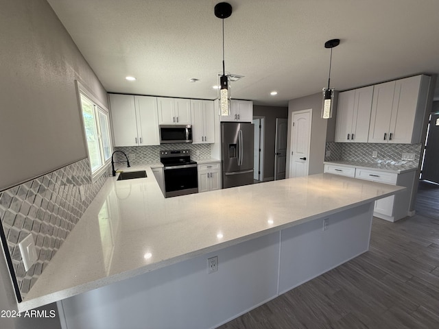2429 E Alameda Dr, Tempe, AZ 85282 - kitchen with stainless steel appliances, wood finished floors, a sink, a peninsula, and tasteful backsplash